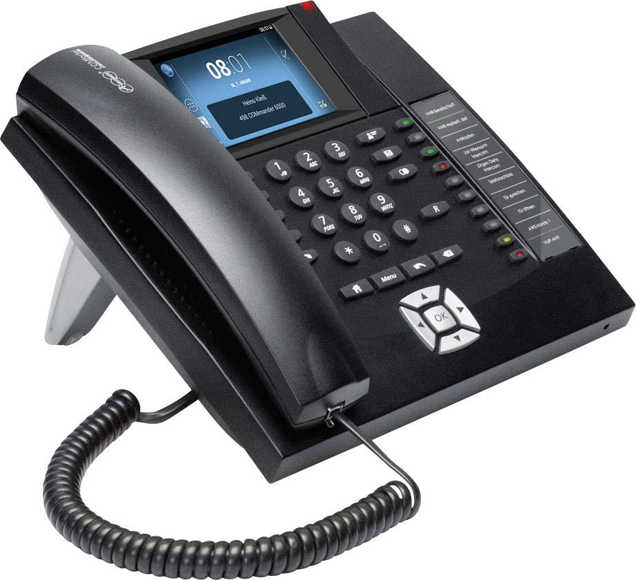 A modern office telephone with a large display, keypad, function keys, and handset on a sleek base station. Ideal for business environments.