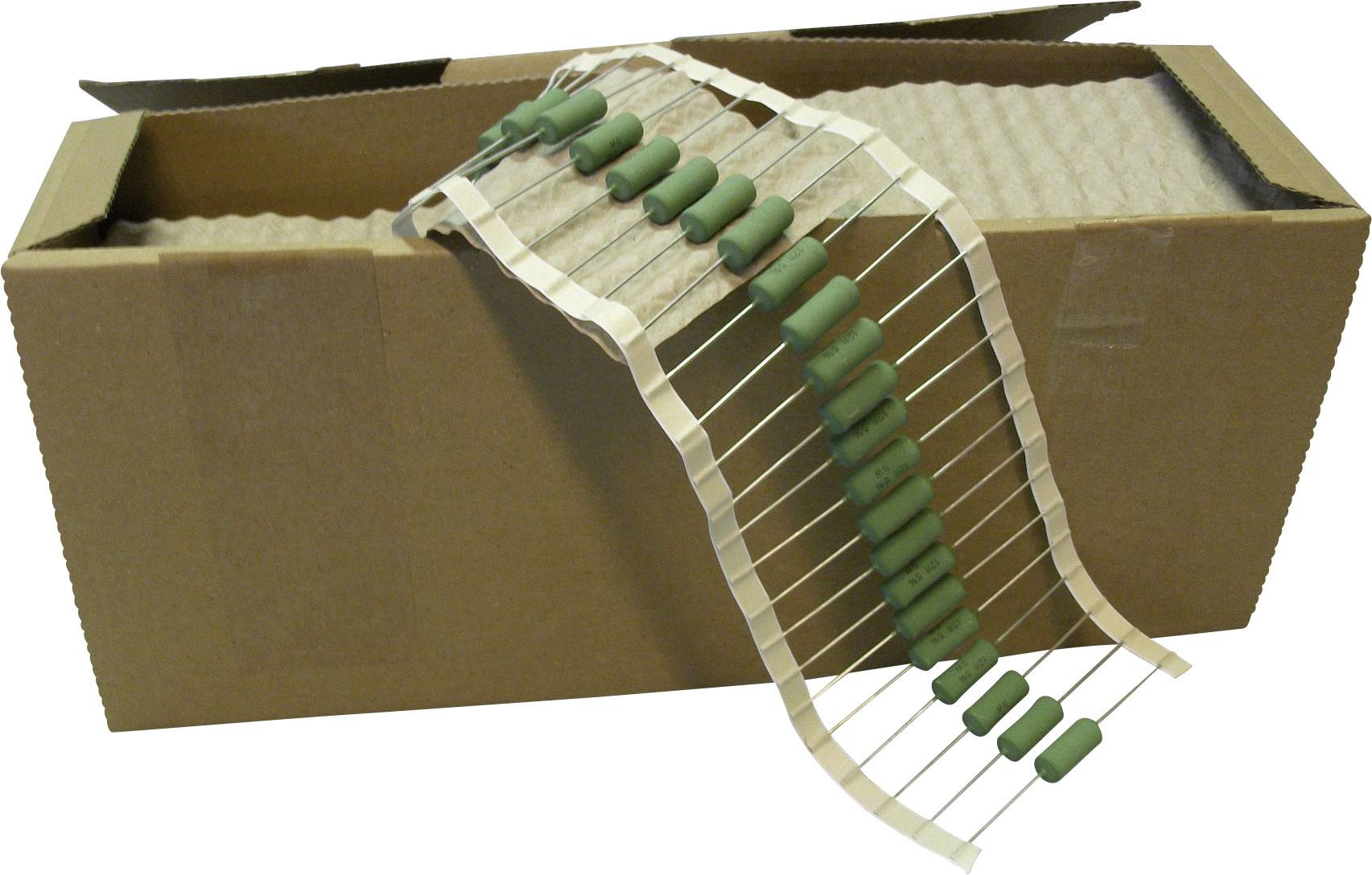 An open cardboard box containing a row of green resistors lined up on a paper tape.