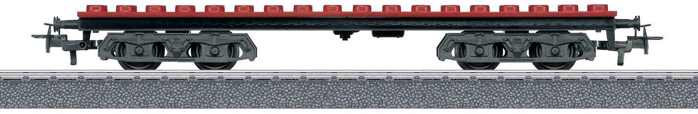 A red and black LEGO train carriage on a grey rail track. The carriage has no superstructures or additional details.