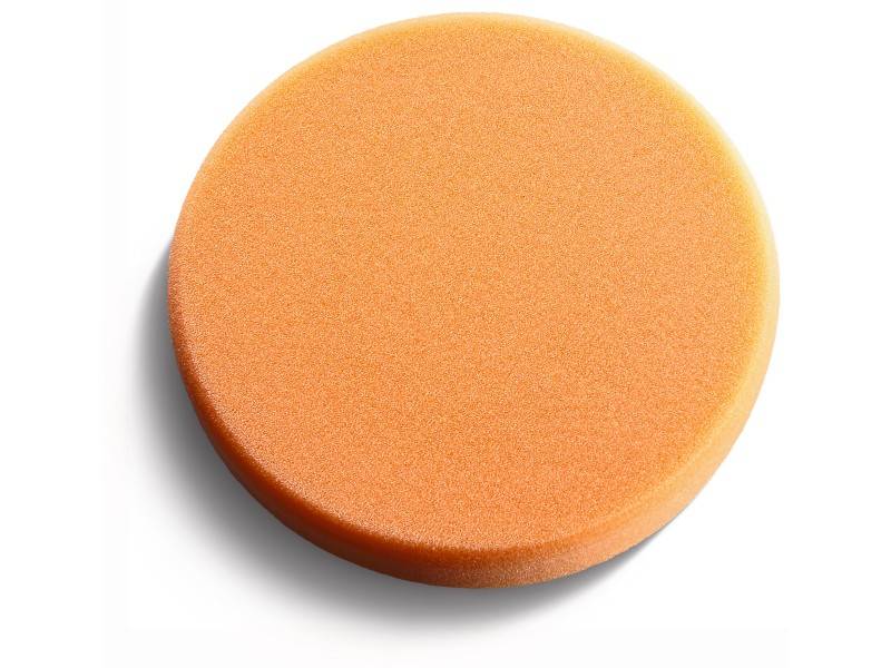 Orange, round polishing pad on a white background, suitable for car care and polishing work.