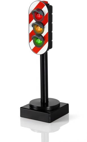 Toy traffic light with red, yellow, and green lights mounted on a black base. Used for simulating traffic situations.