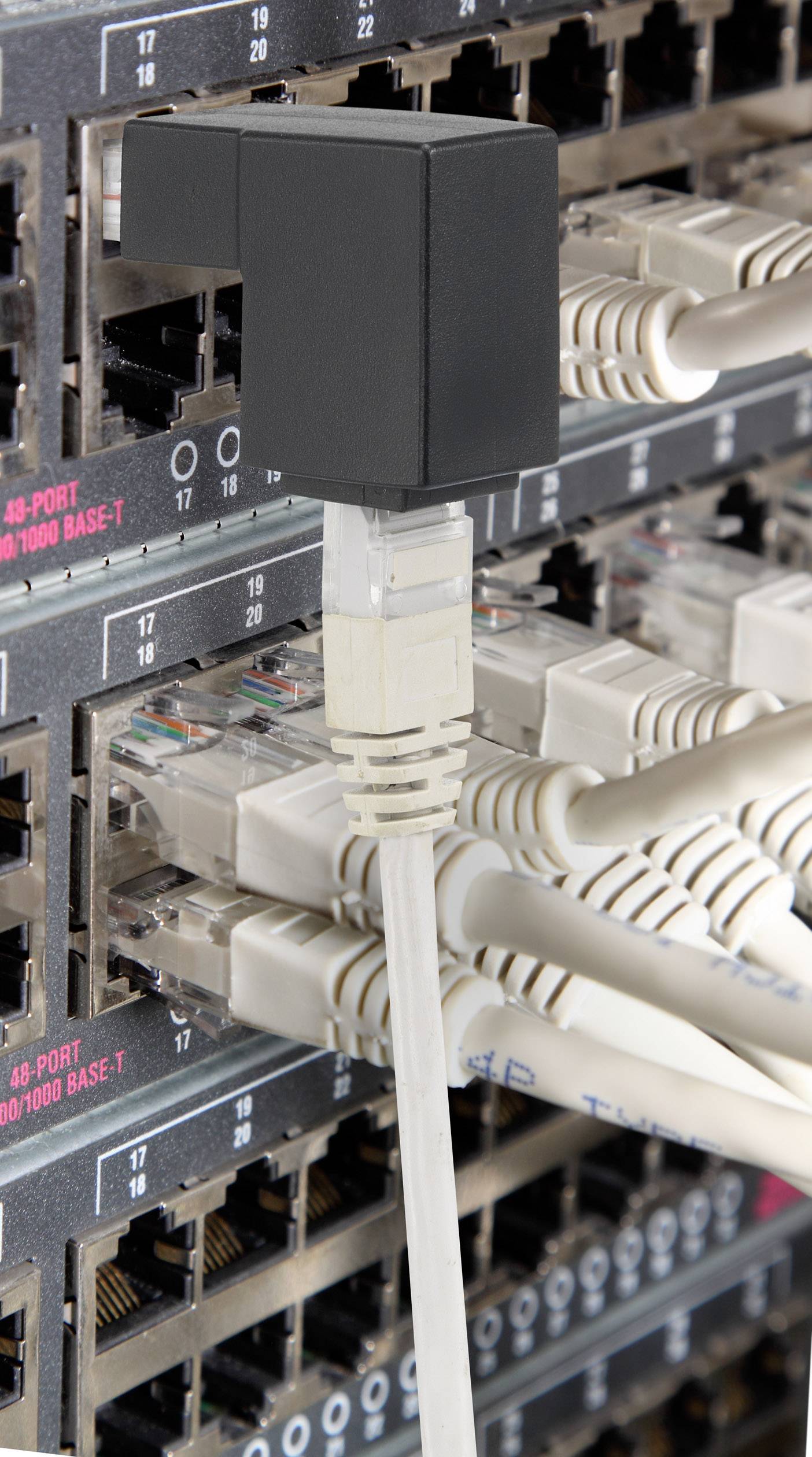 A network switch with numerous plugged-in Ethernet cables, enabling connectivity and data transmission between devices.