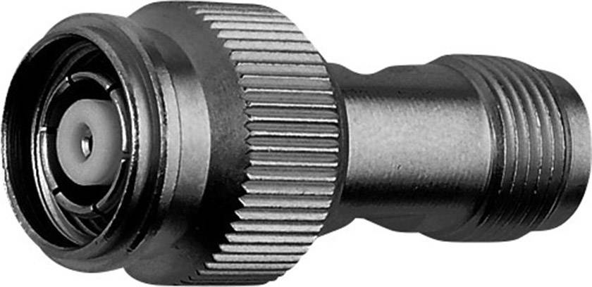 A metal adapter, cylindrical, with a knurled surface for better grip, used for connecting cable ends in technical devices.