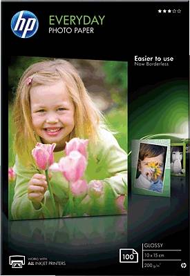 A smiling child with pink tulips on a photo paper packaging by HP, 100 sheets, 10x15 cm, glossy, for inkjet printers.