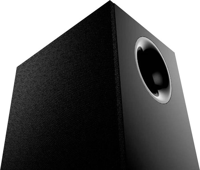 Black speaker with fabric cover and visible bass reflex port, photographed from a low perspective.