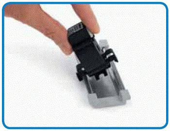 A hand is holding a black component over a grey mounting bracket, potentially part of an electrical connection or plug system.