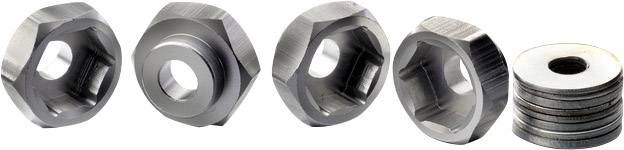 Four silver, hexagonal nuts and a stack of flat, round washers lined up. They are made of metal and gleam slightly.