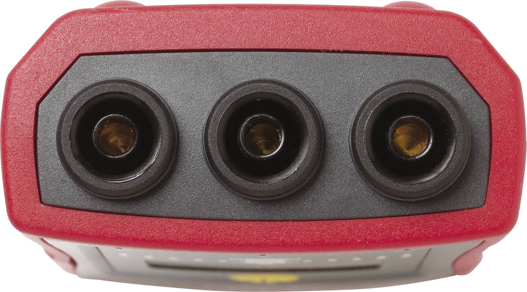 Three-pin electrical connector on a red electronic device, most likely a measuring instrument or charger.