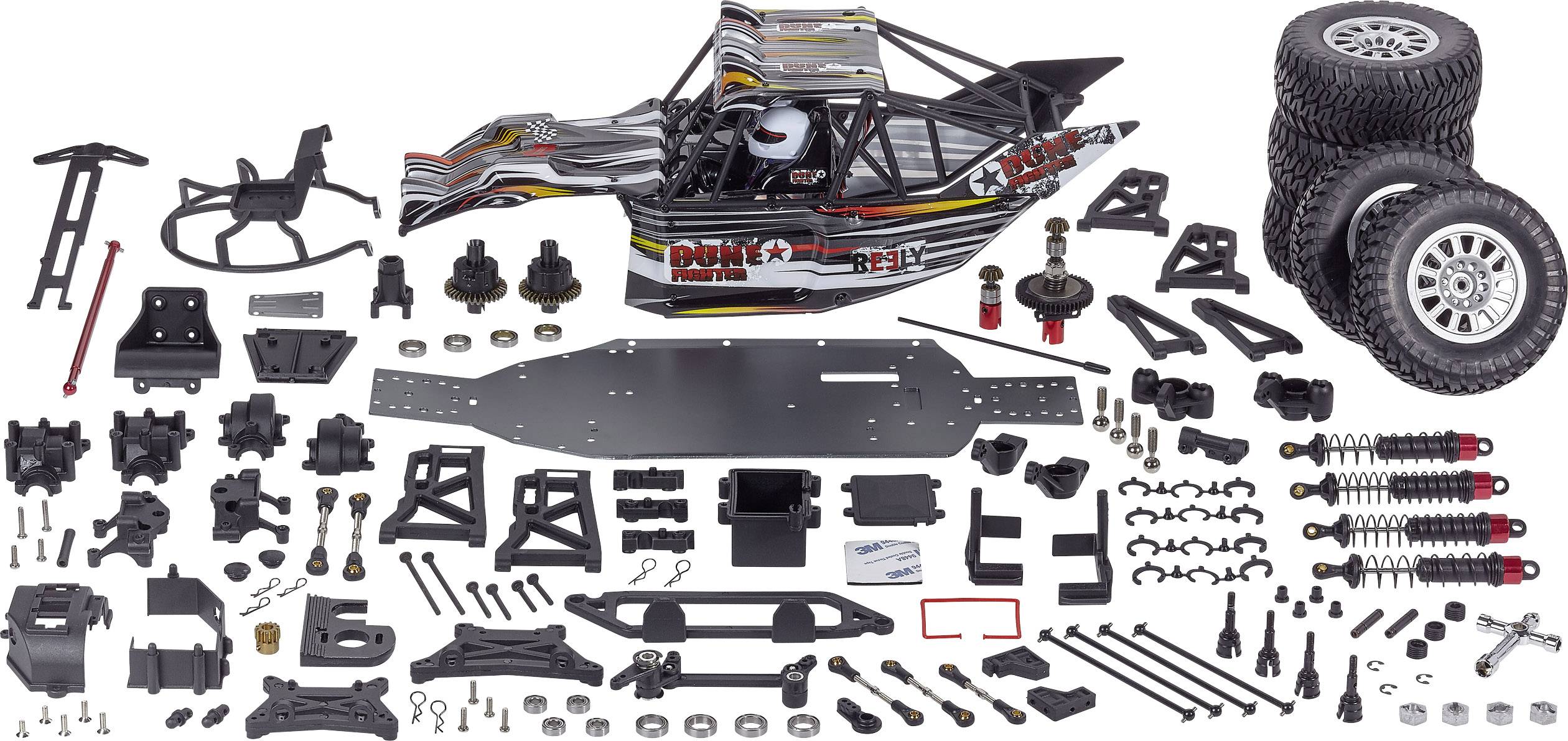 A radio-controlled car kit with numerous individual components, including bodywork, tyres, chassis, suspension, and various screws and nuts.