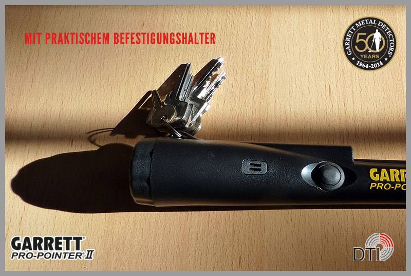 A bunch of keys hangs on a black metal detector labelled 'Garrett Pro-Pointer II'.