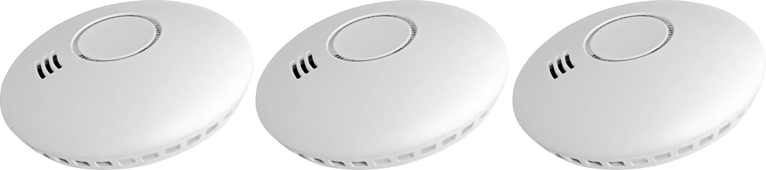 Three white smoke detectors side by side, same size and shape. Each device has a central control panel and ventilation slots on the side.