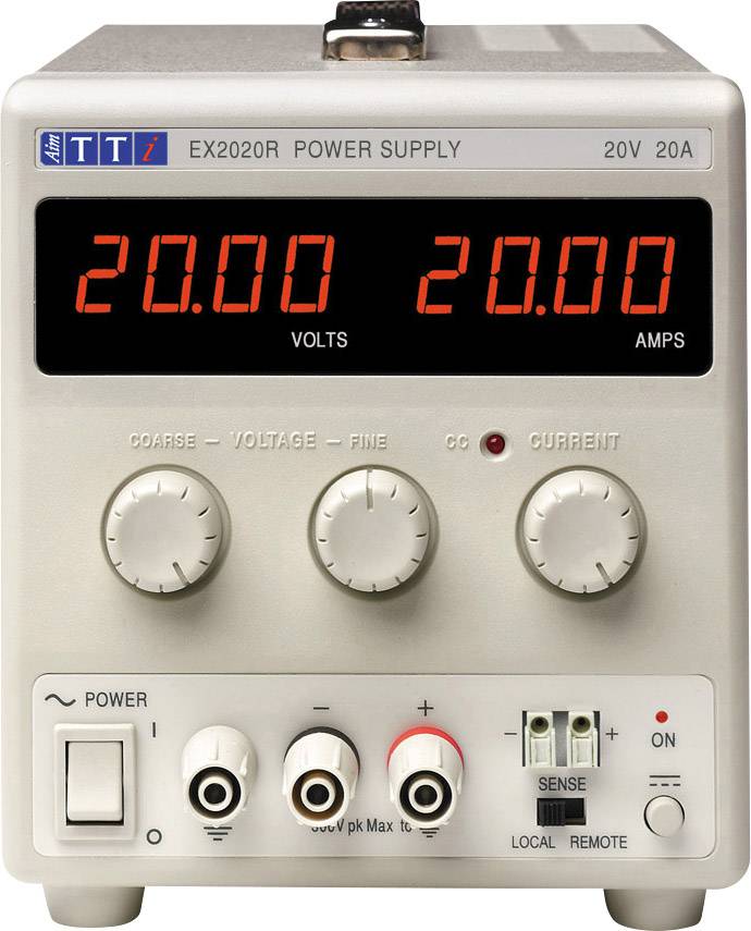 A laboratory power supply with a digital display showing '20.00 VOLTS' and '20.00 AMPS'. Rotary knobs for voltage and current.