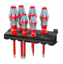 A set of six screwdrivers with red handles and grey inserts, neatly arranged in a black holder.