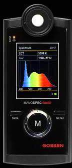 A handheld measuring device displays a colour spectrum on the screen with values: CCT 5598 K and 1446.9 lx. Brand name 'Gossen' visible at the bottom.