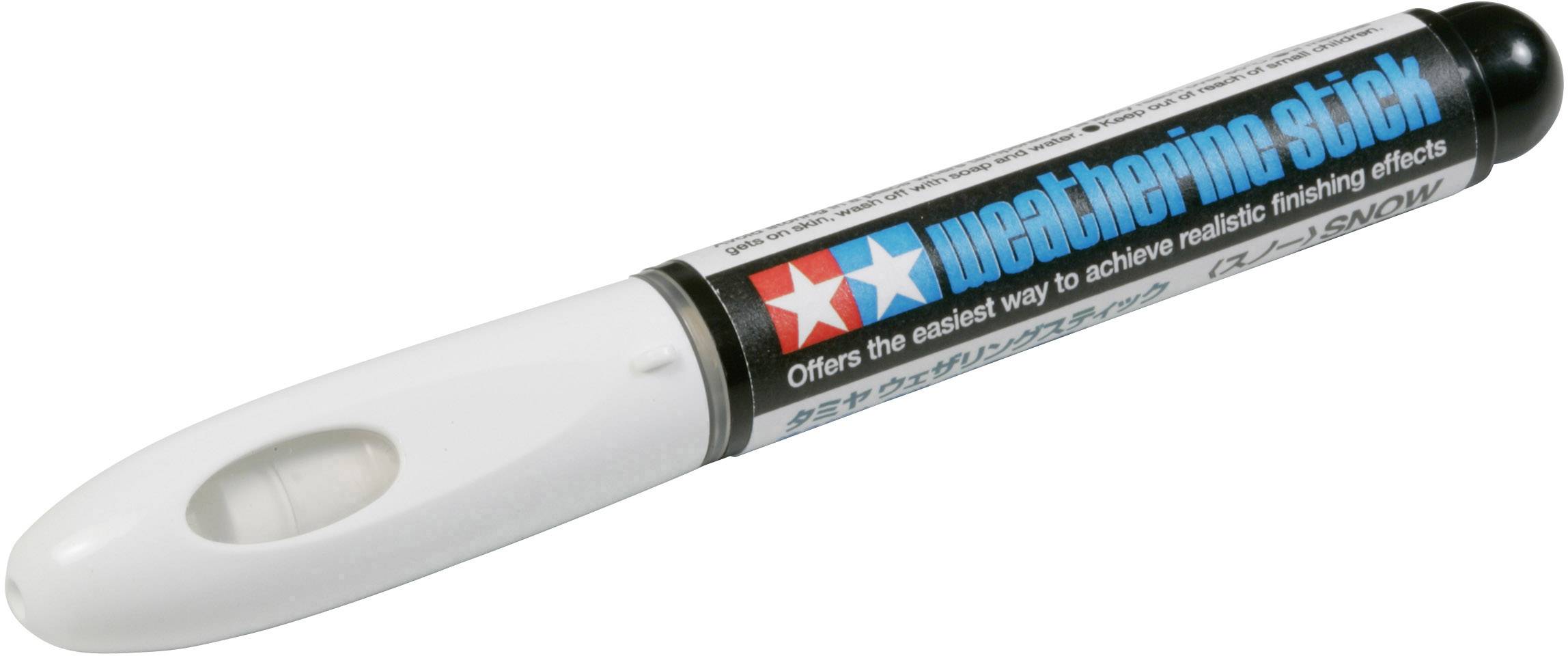 A white marker pen with a black cap, on which 'weathering stick' is written, is lying on a table.