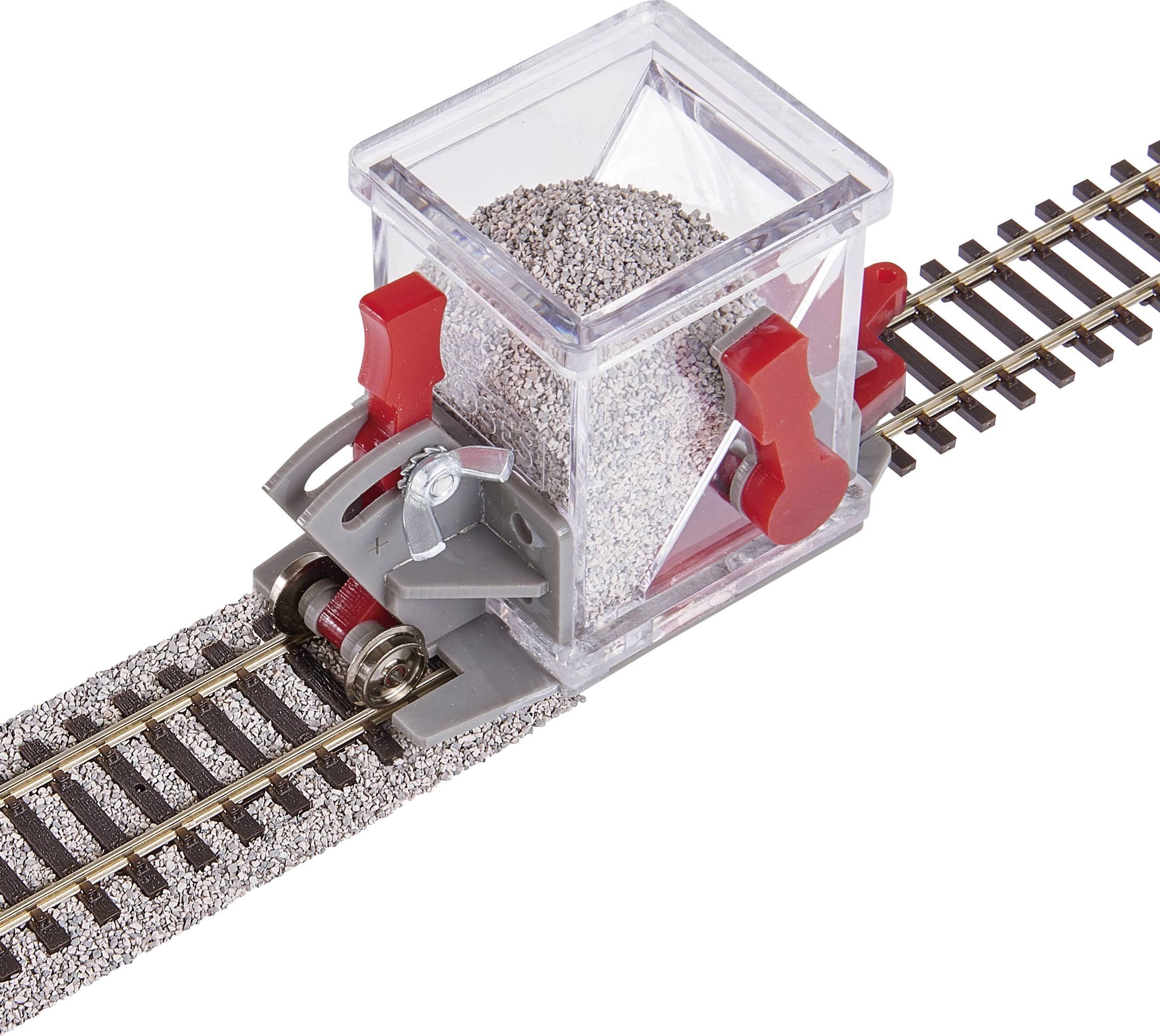 A model railway train with a transparent container on the tracks, filled with gravel, demonstrating the transport of materials.