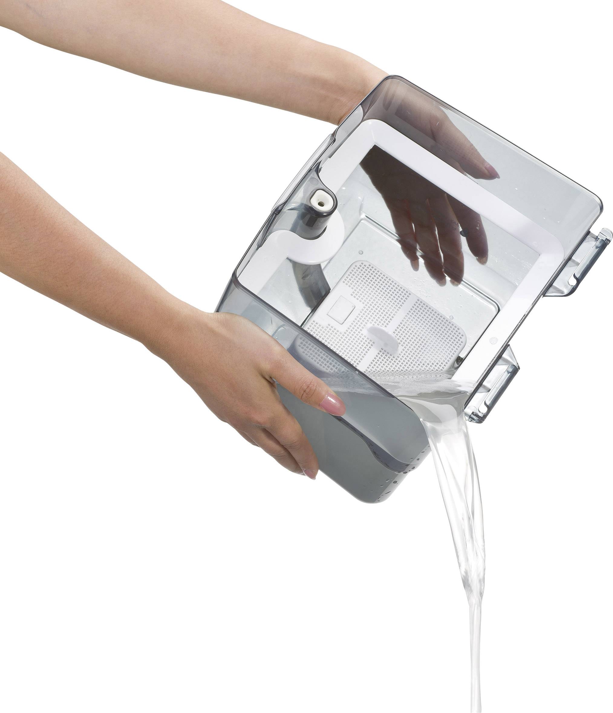 A person is holding a transparent water container, pouring water from a small opening.