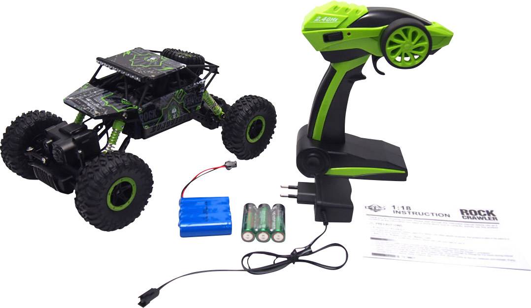 A remote-controlled off-road style car with large wheels. Next to it, a remote control, batteries, and a charger. Instructions are laid flat.