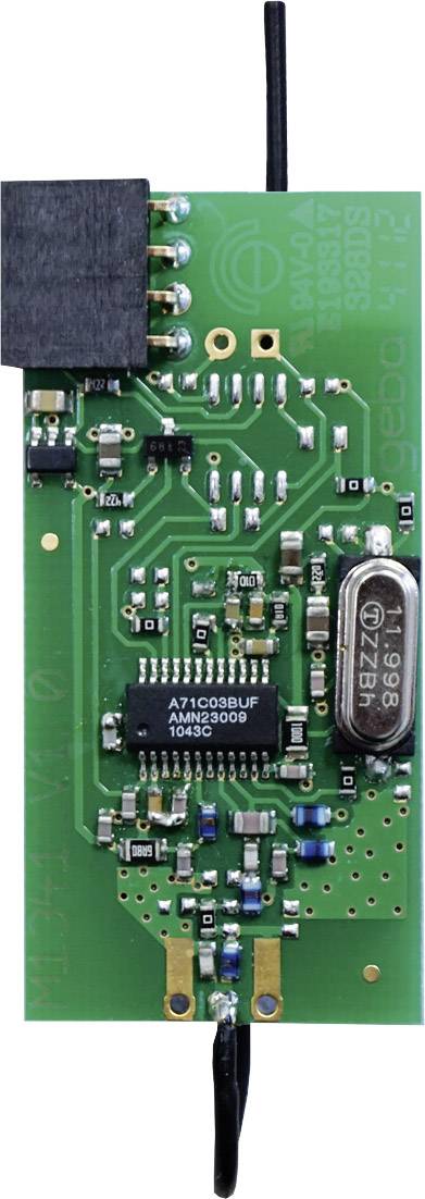Close-up of a green circuit board with various electronic components, including a microchip, resistors, and capacitors.