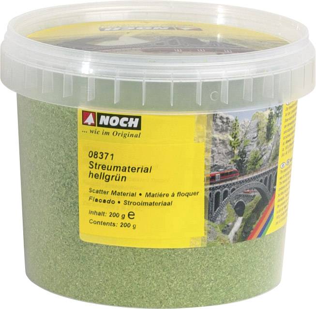Plastic container with light green scatter material 200 g from the brand 'Noch', pictured in front of a model train background.