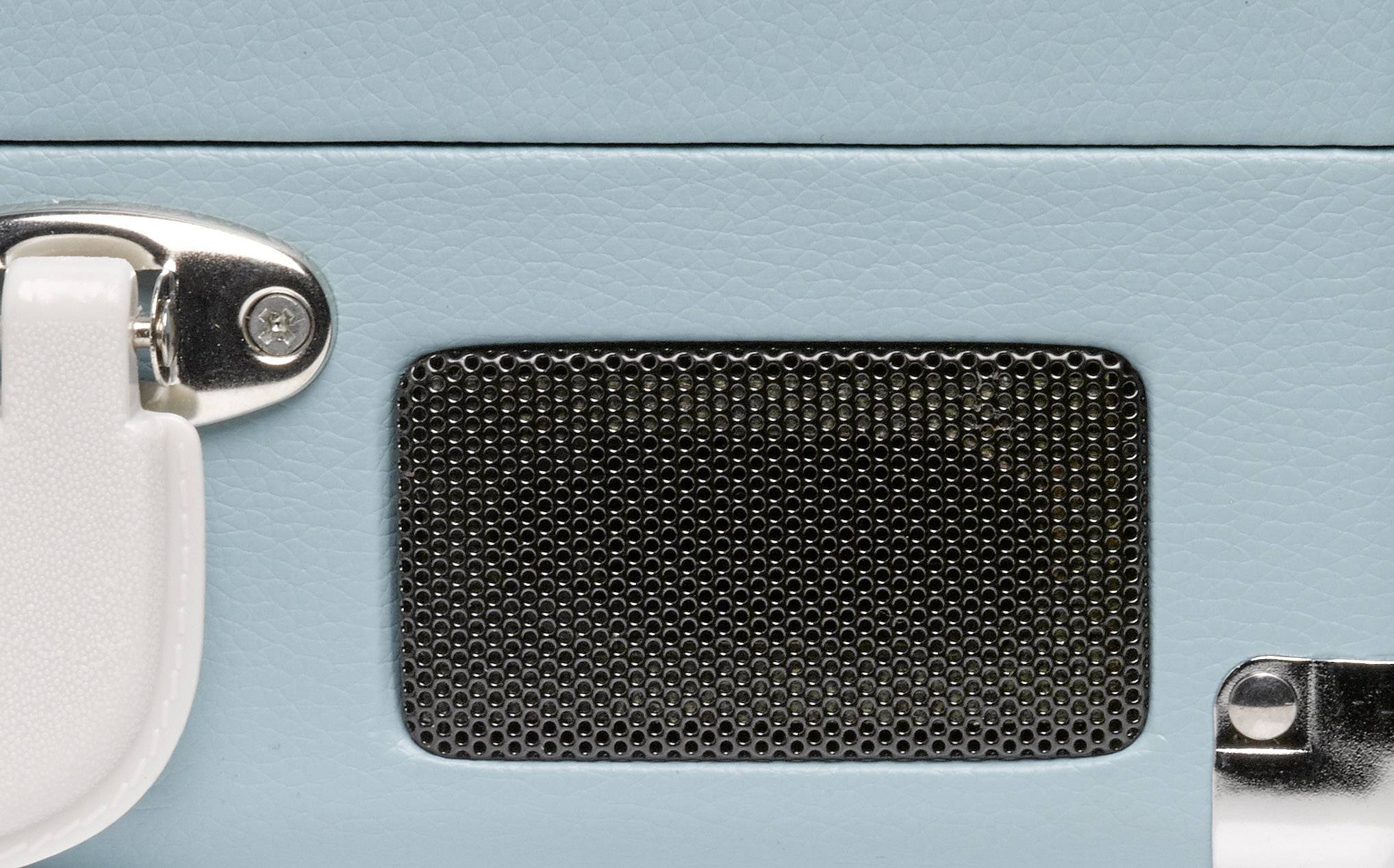 A part of a blue speaker with a white metal cover and a black speaker grille is visible.