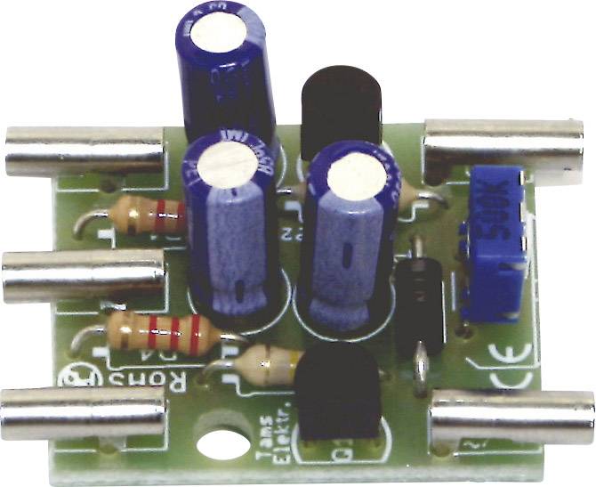A green electronic circuit board with blue and black capacitors, along with multiple resistors and solder points.