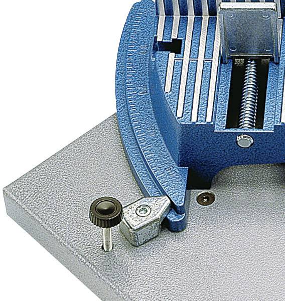 A blue metal G-clamp with a screw mechanism on a grey surface, used for securely holding workpieces.