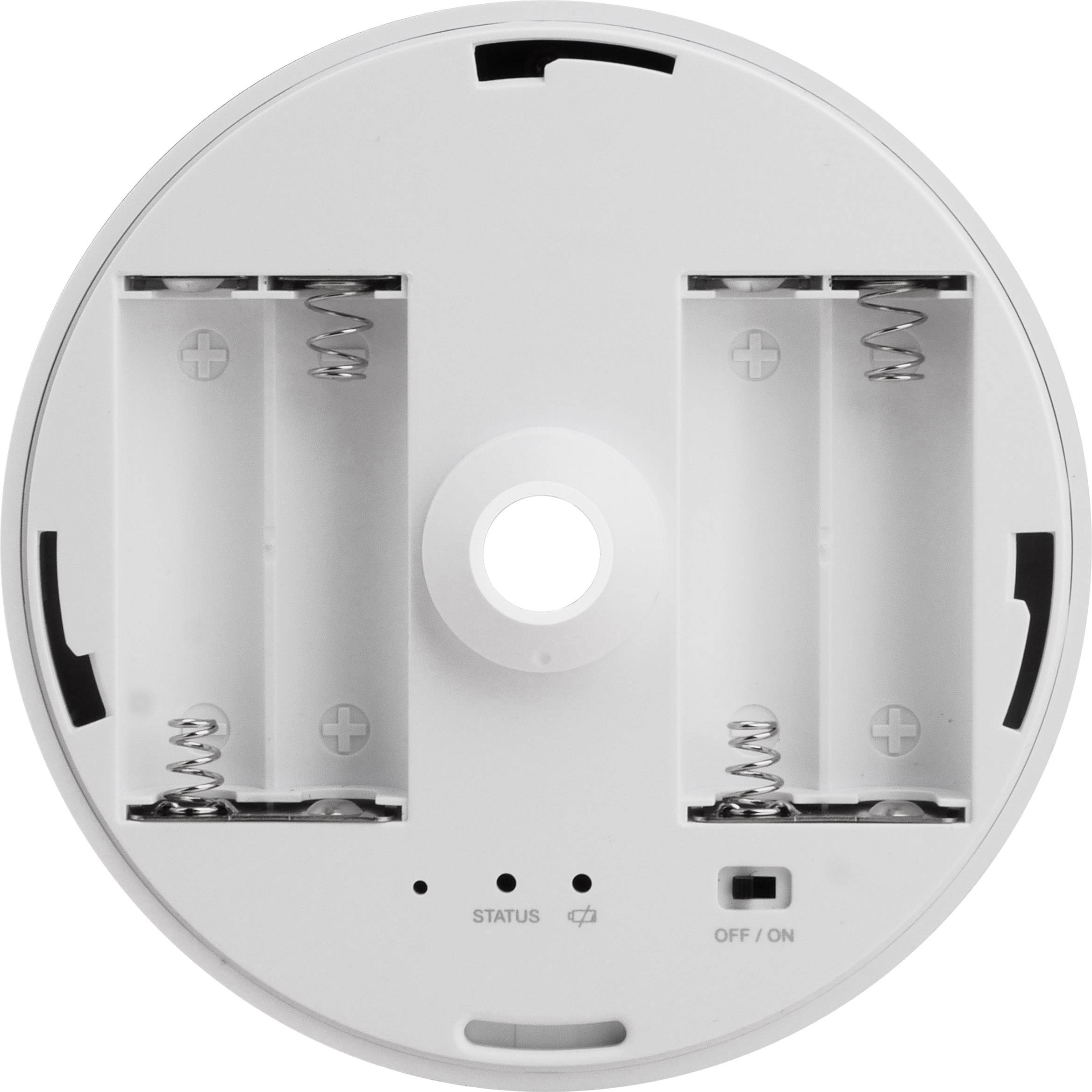 Back of a round device with two battery compartments, a status light, and a power on/off switch.