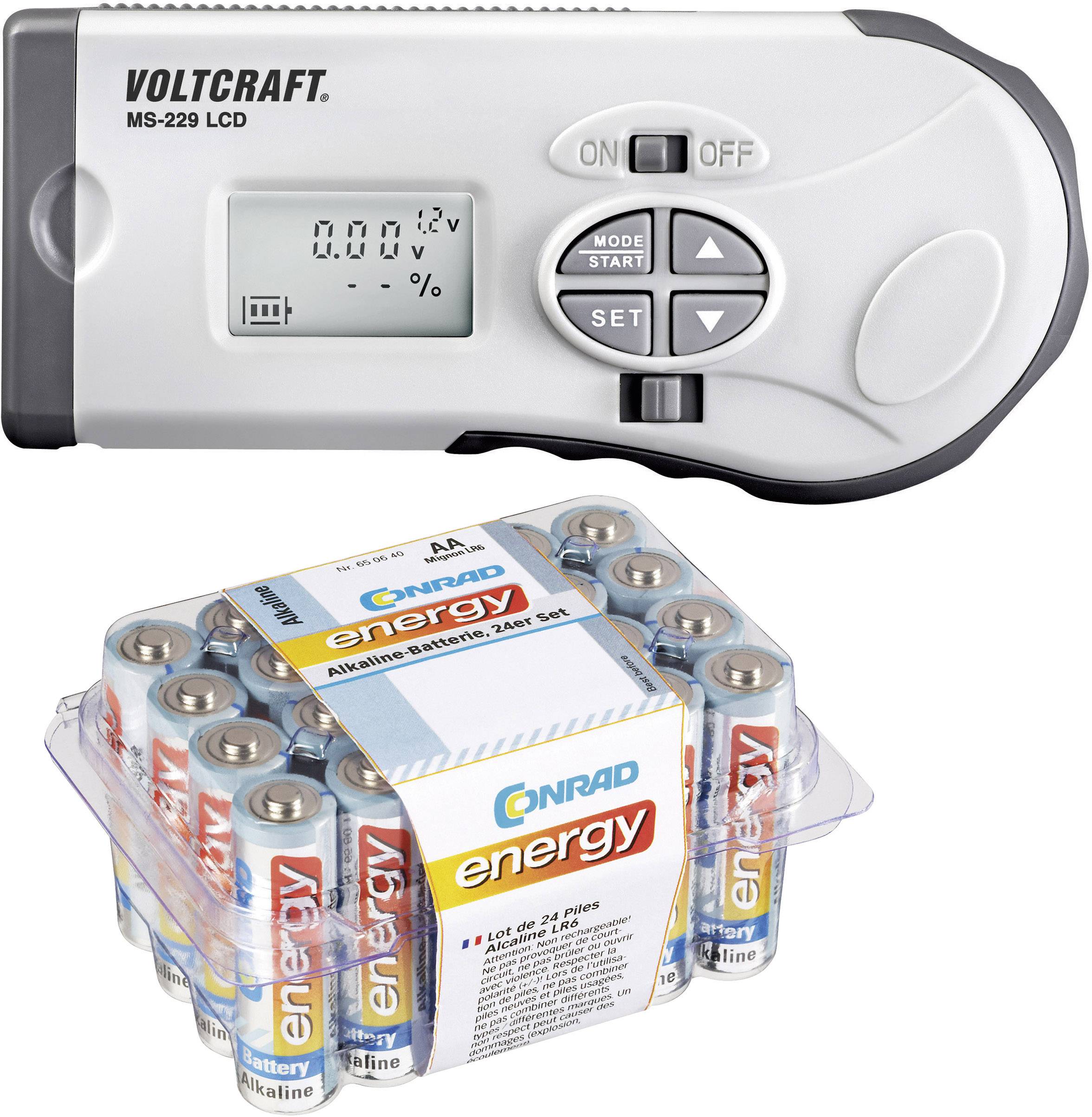 A digital measuring device with an LCD display shows 0.00 V. Underneath are 24 AA batteries in a plastic pack labelled 'CONRAD energy'.