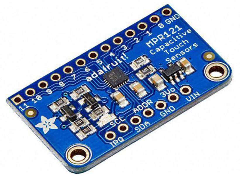 Capacitive touch sensor MPR121 on a blue circuit board with multiple connections and electronic components, suitable for touch controls.