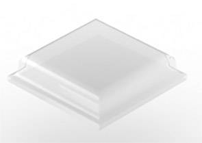 A transparent, square object with slightly rounded edges, resting on a white surface.