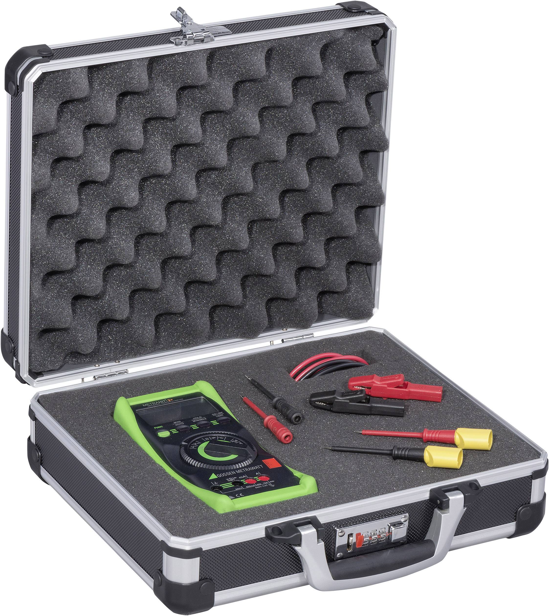 An open suitcase reveals a green multimeter with cables and clamps, nestled in grey foam.
