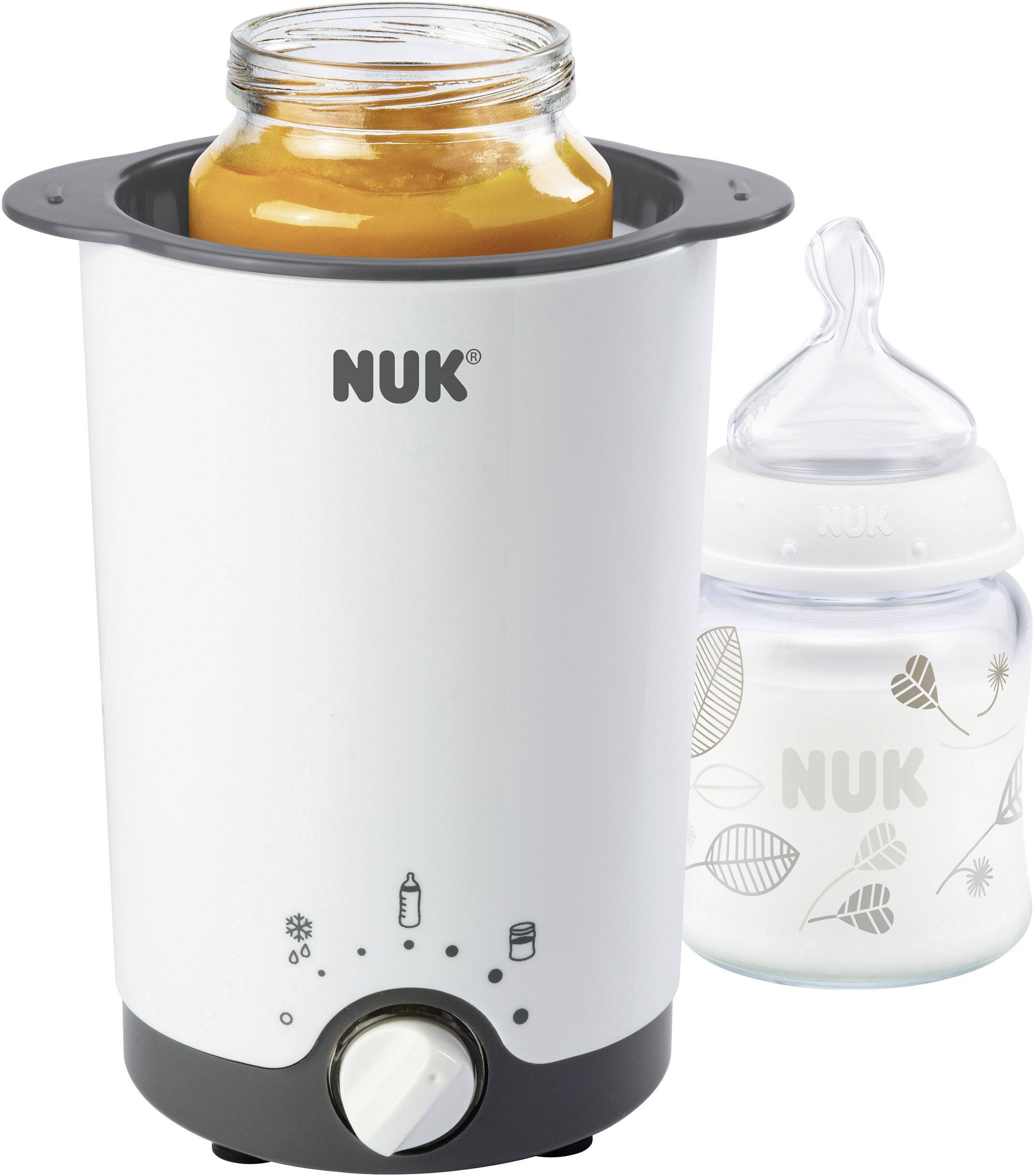 In the picture, there is a baby food warmer with a jar of baby food and a 'NUK' baby bottle.