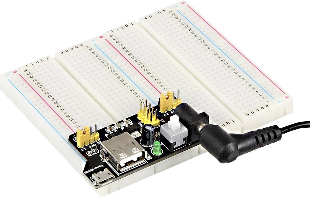 Breadboard with attached power module, yellow and black connectors on top, power supply cable on the side.