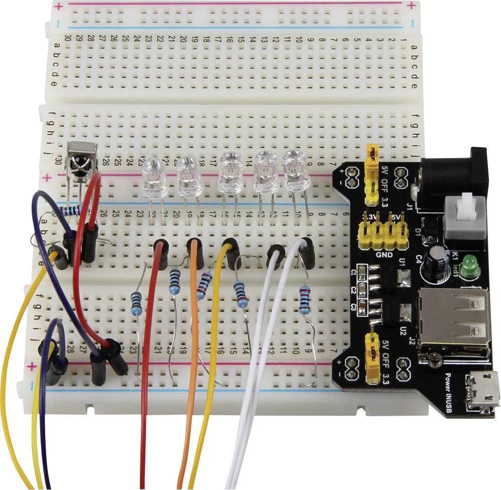 A breadboard with electronic components and LEDs. Several wires connect the components for a circuit demonstration.