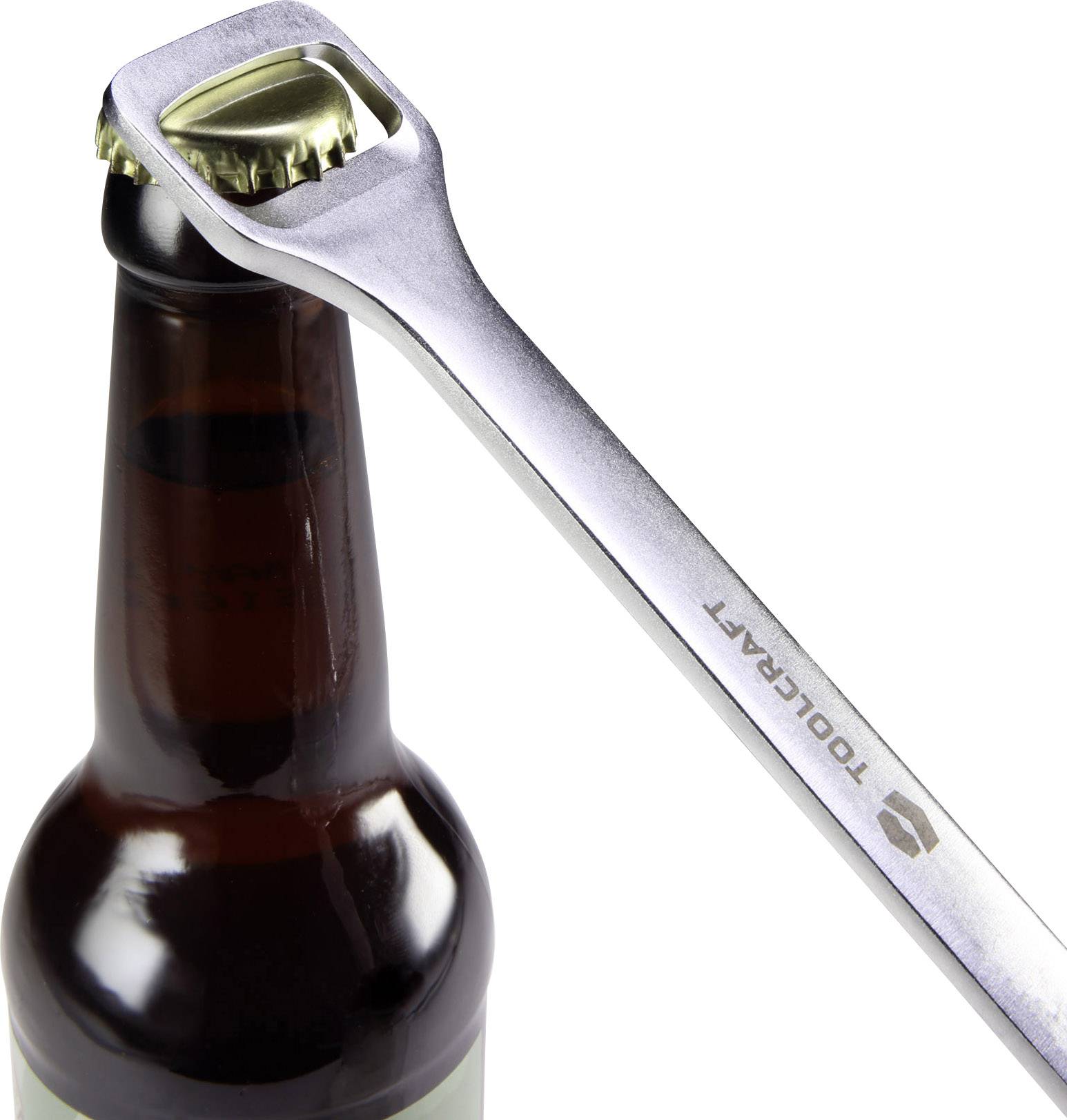 A metal bottle opener removes the bottle cap from a brown glass bottle.