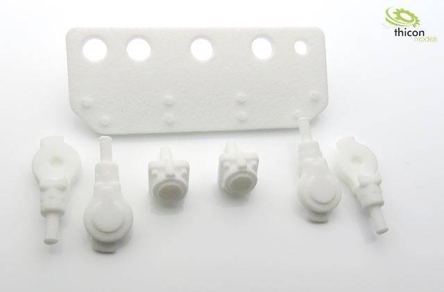 A white plastic component set with multiple parts, including a rectangular piece with holes.