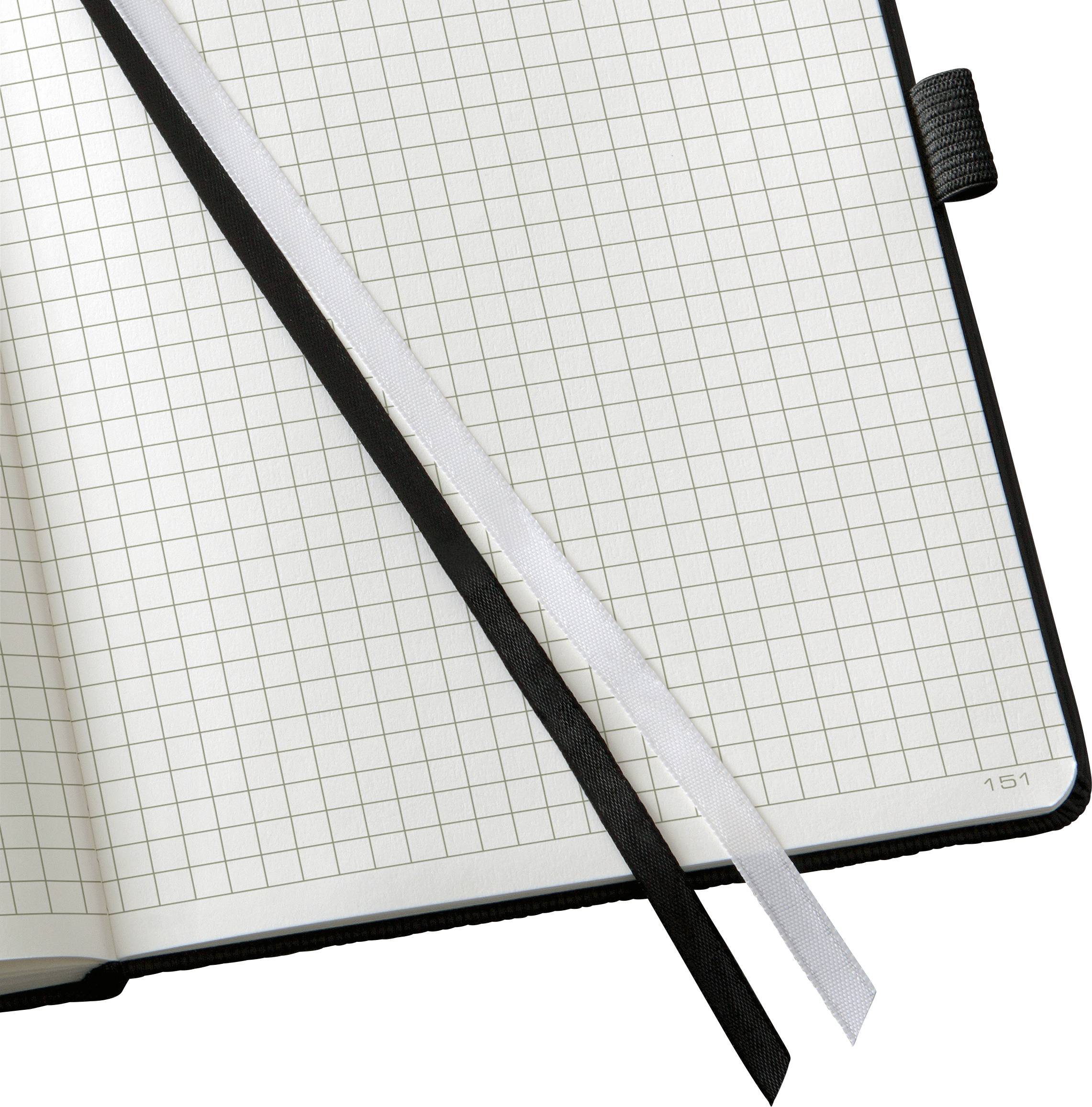 An open notebook with squared pages and two bookmarks, one black and one white.