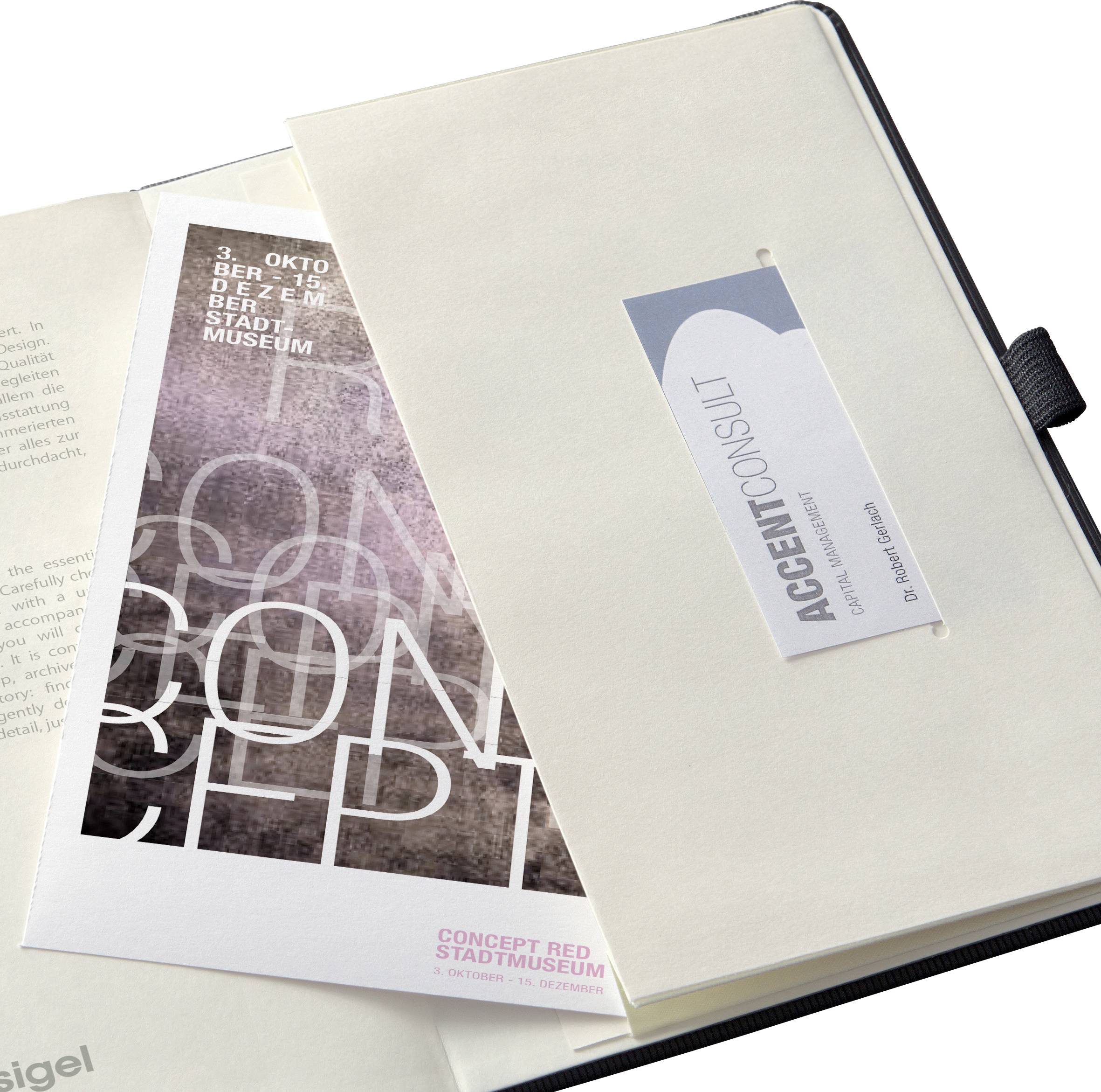 A brochure with the inscription 'Concept Red City Museum' is tucked into an open folder. Beside it is a business card.