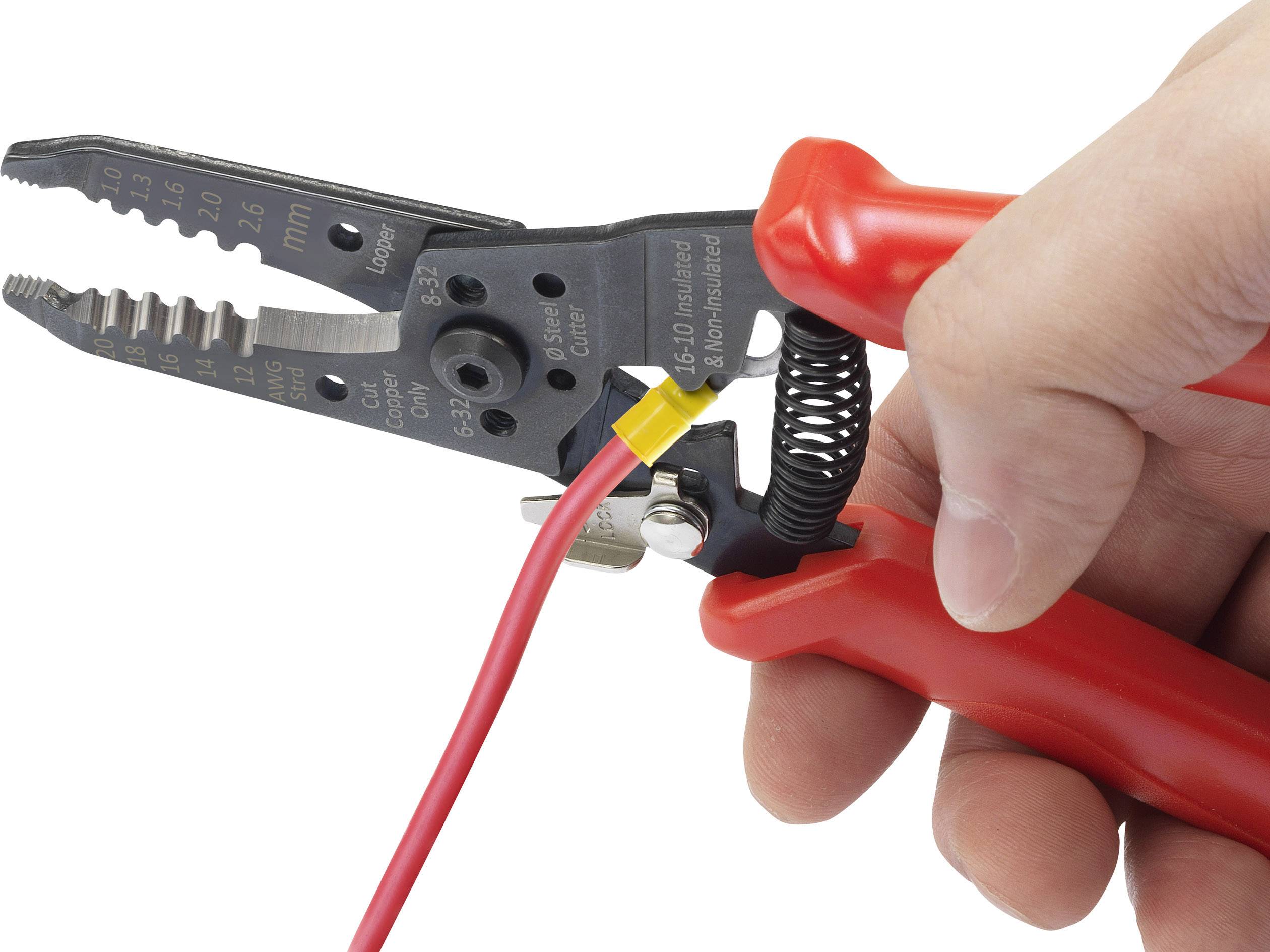 A hand is holding a red wire stripping pliers, gripping a red cable with a yellow plastic section.