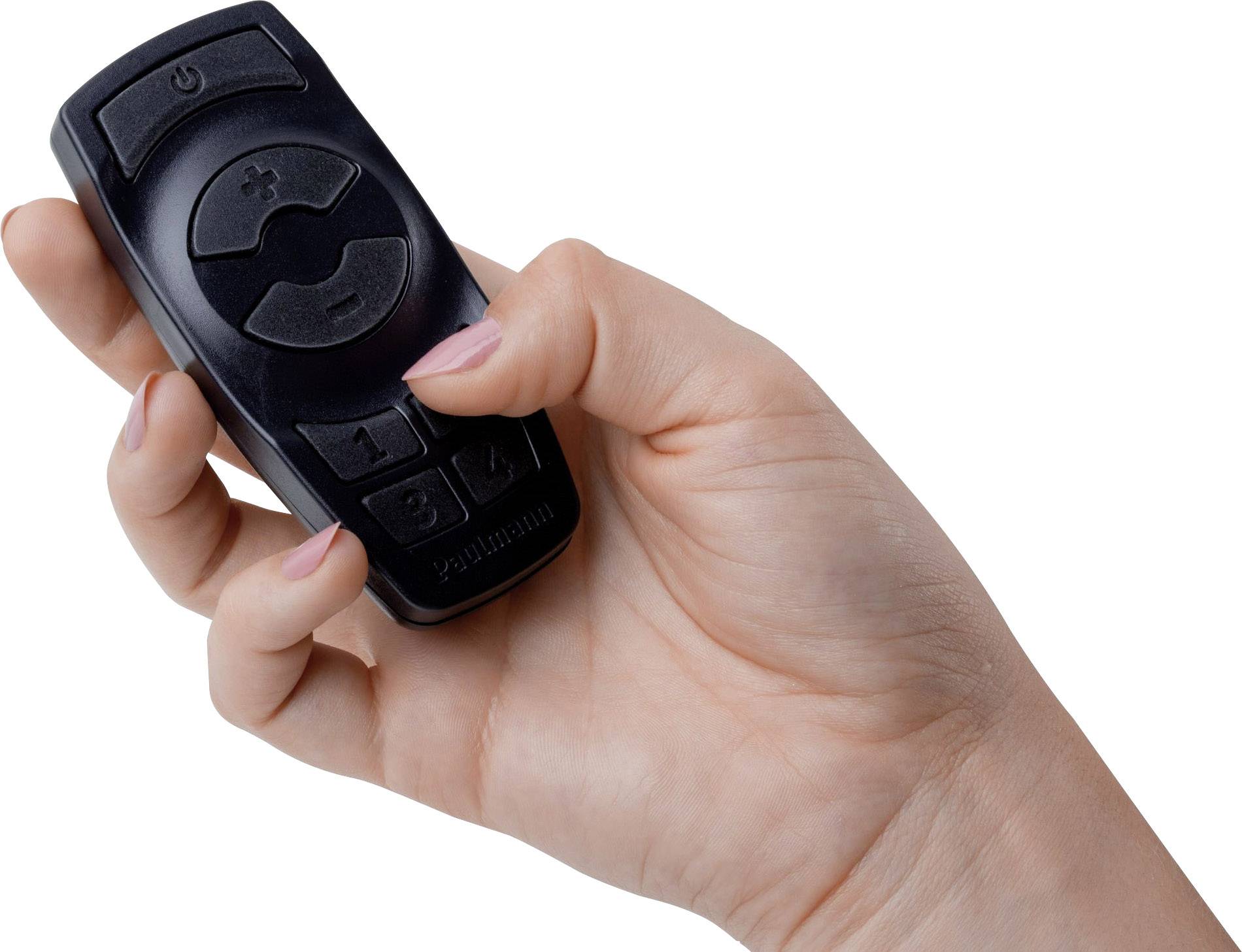 A hand is holding a black remote control with volume control buttons and a power on/off switch.