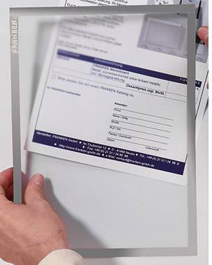 A person is holding a transparent desk mat with a printed form underneath. The form displays address fields and text.