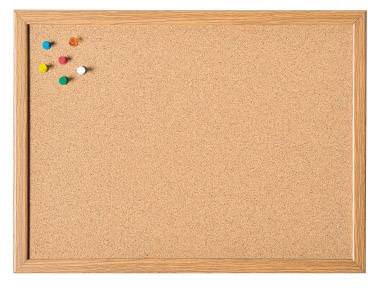 A blank pinboard with a wooden frame. Colourful drawing pins are located in the top left corner.