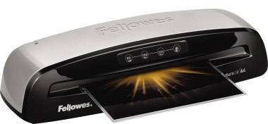 A Fellowes laminating machine pulls a sheet of paper through. The top side displays the brand logo and control buttons.