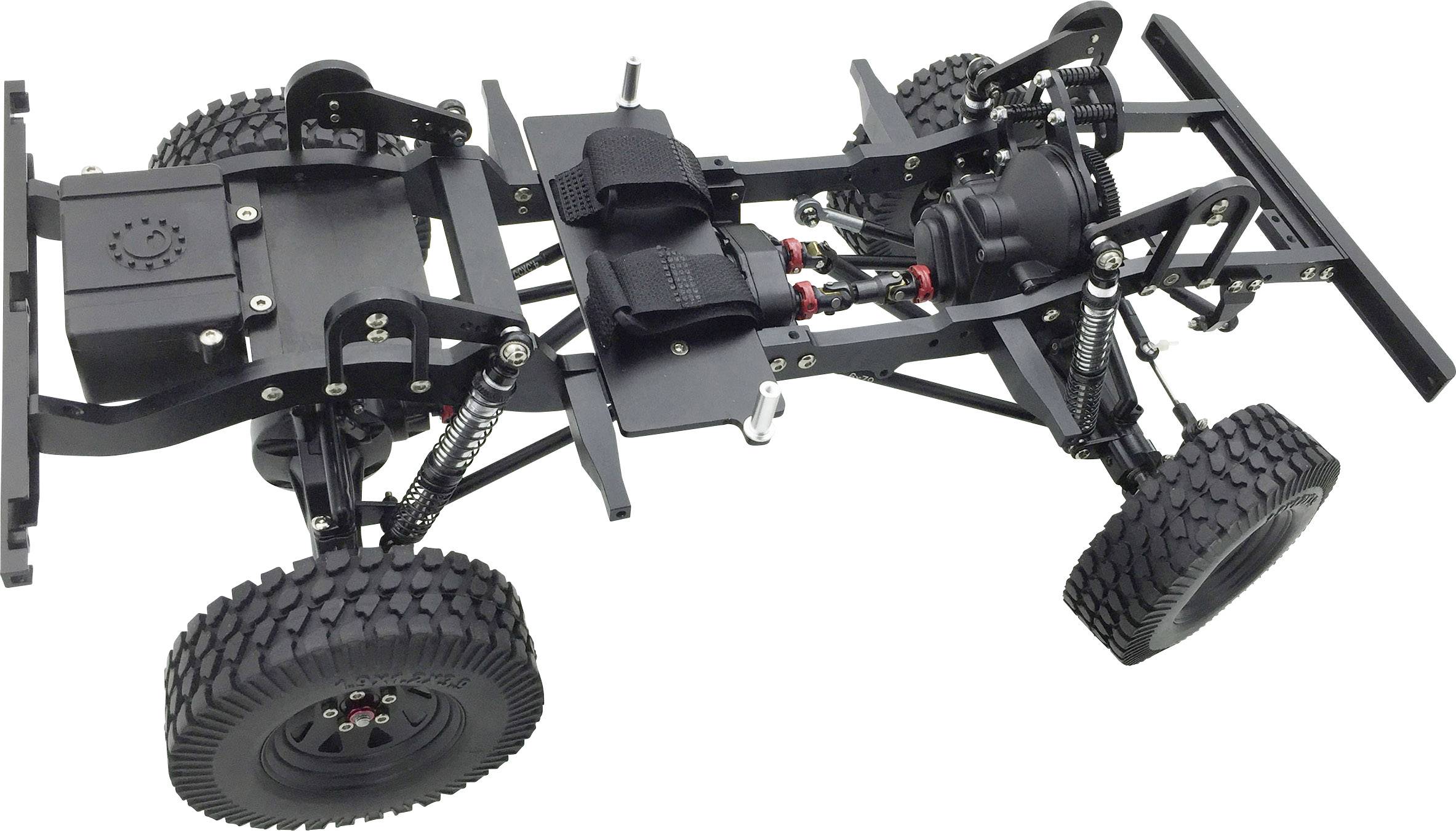 A model car chassis with chunky treaded tyres, suspension, and a metal frame, ready for assembling an off-road vehicle.