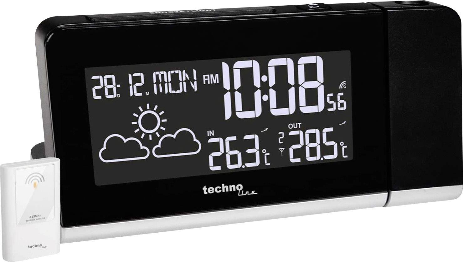 Black digital alarm clock shows date '28.12 Monday', time '10:08', weather with sun and clouds, indoor temperature '26.3°C', outdoor temperature '28.5°C'.