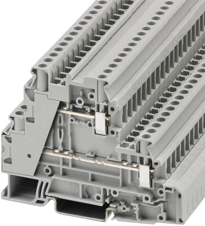 A grey terminal block module with multiple connections and copper conductors, used in electrical switchgear for connecting wires.