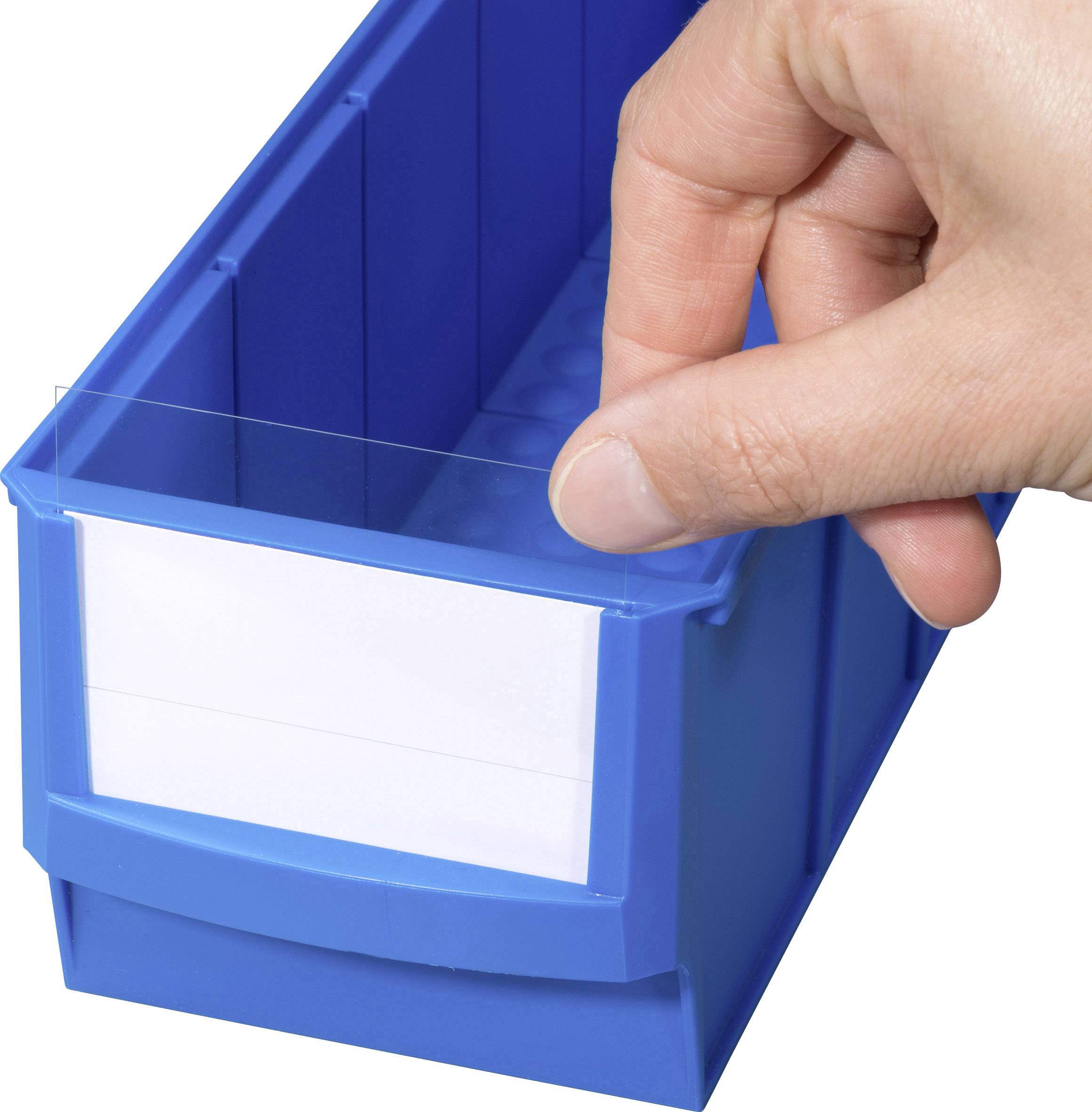 A hand places a label into a blue plastic container.