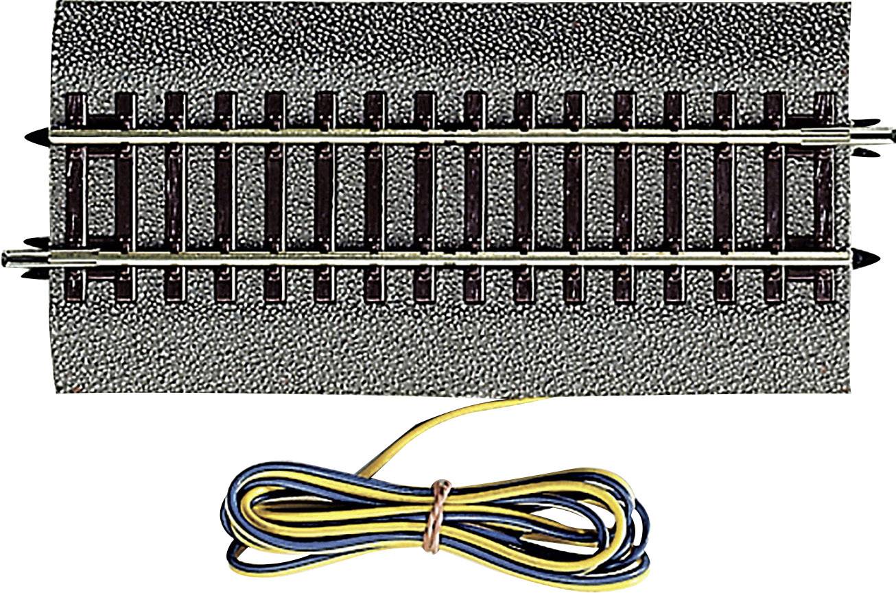 Section of model railway track, with bundled, coloured cables for power supply.