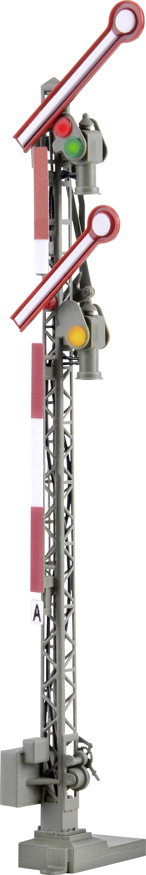 Railway signal with three signal arms in different positions, showing a combination of green, yellow, and unlit lights.